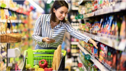 Woman Reaching For Item On Grocery Store Shelf